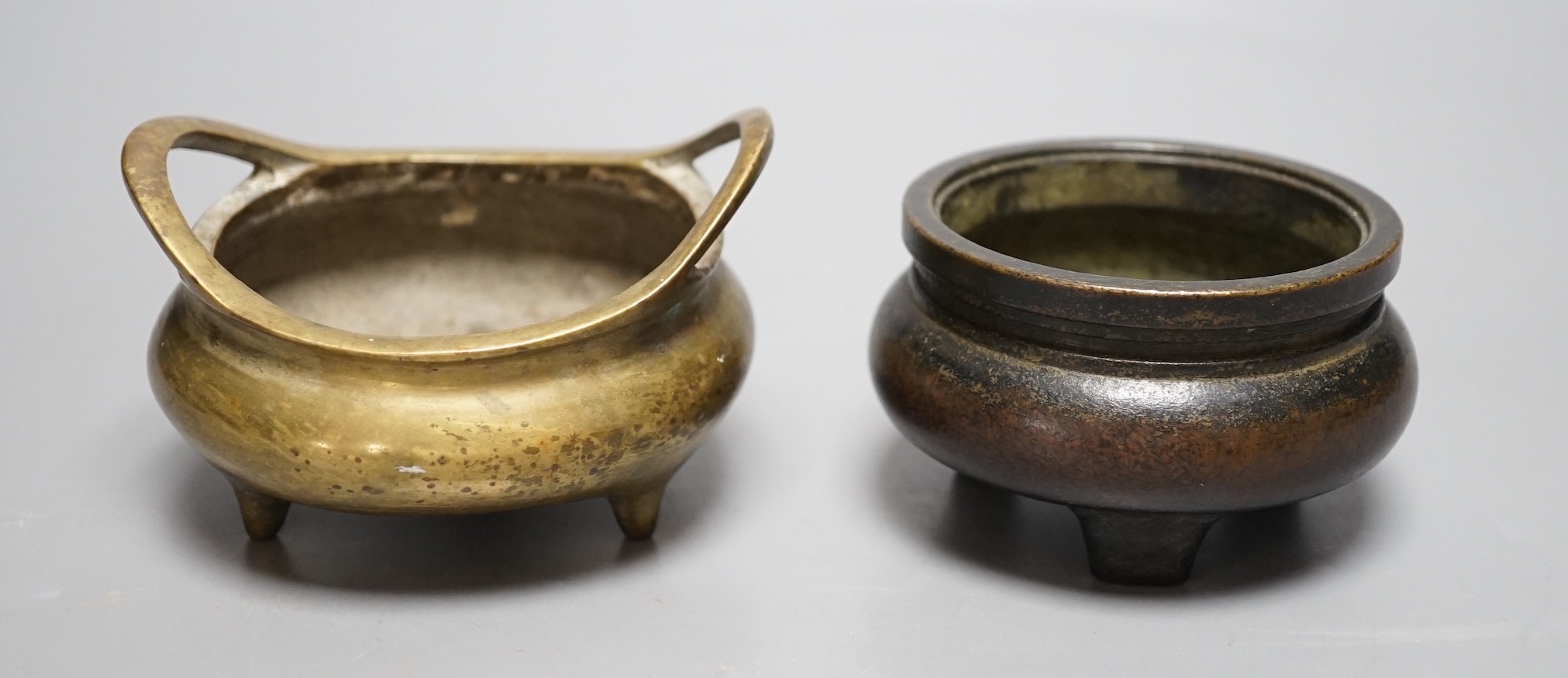 Two Chinese bronze tripod censers largest 10cm handle to handle